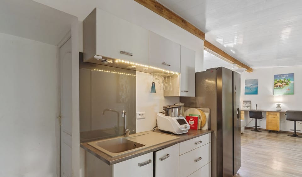 Modern kitchen with stainless appliances and clean design.