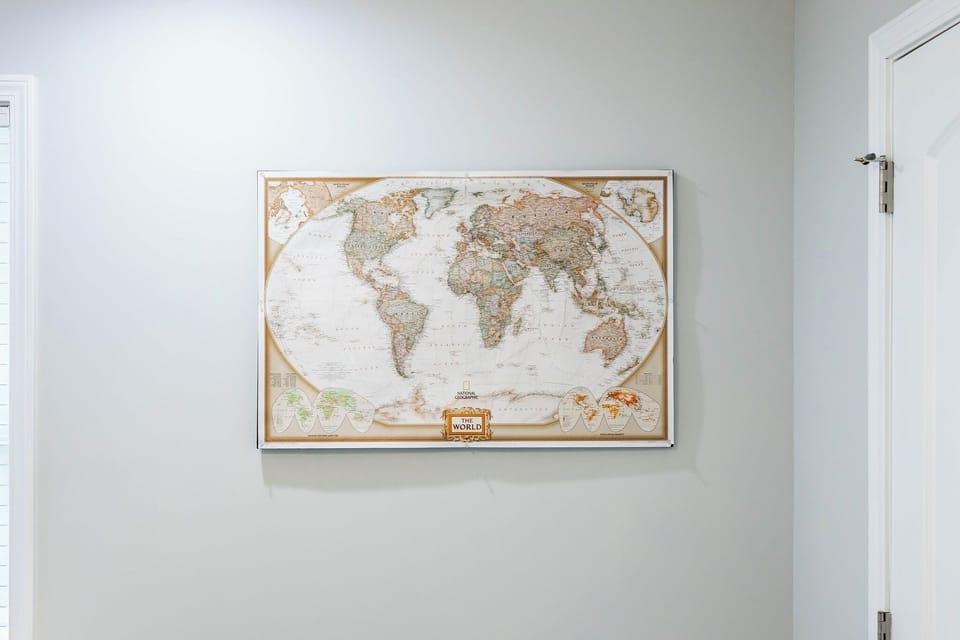 A stylish map wall art adds character and inspiration to the space.
