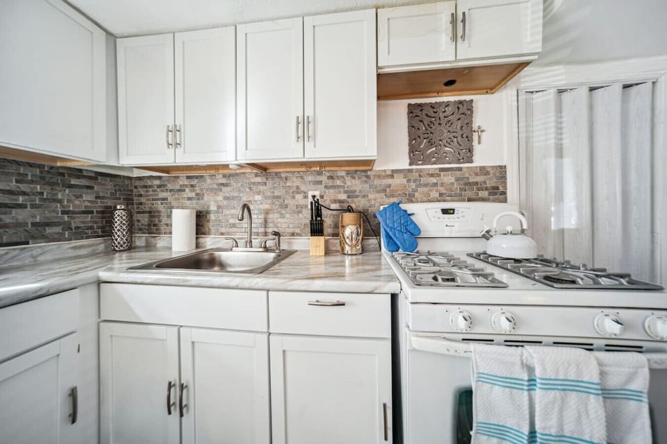 The kitchen is small but well-stocked for your stay