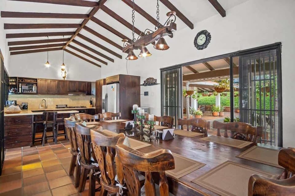 Indoor kitchen and dining table with space for 12 people.