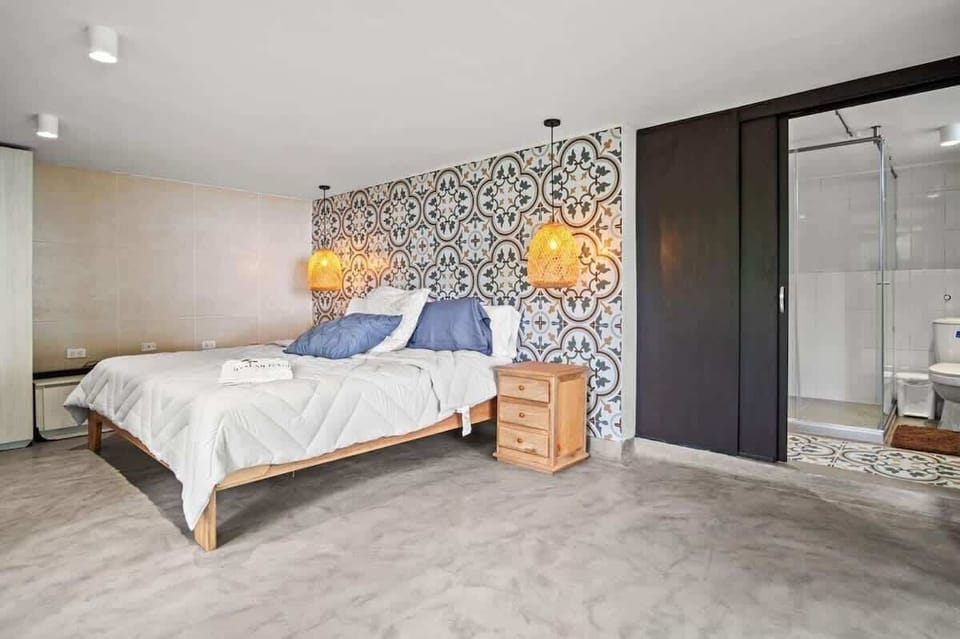 King size bed with stowaway mattress below the bed. Direct access to private bathroom. 