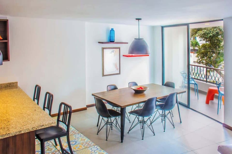 The 6-person dining table that connects to the balcony.