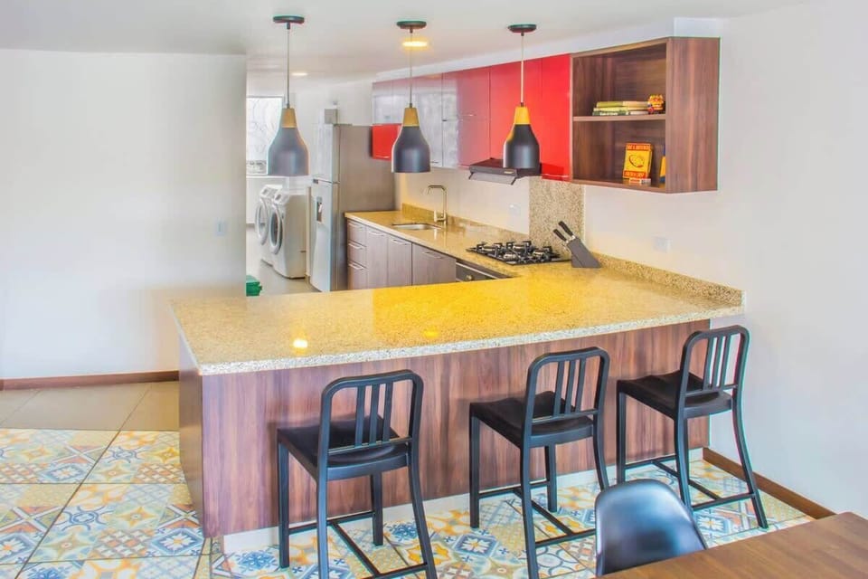 Open kitchen with a big counter and 3 high chairs. Great for entertaining the chef or using as a work station.