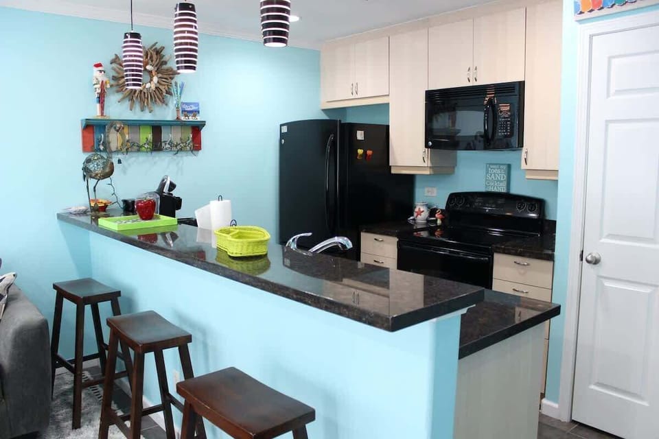 A well-decorated kitchen with cabinets for your food storage.