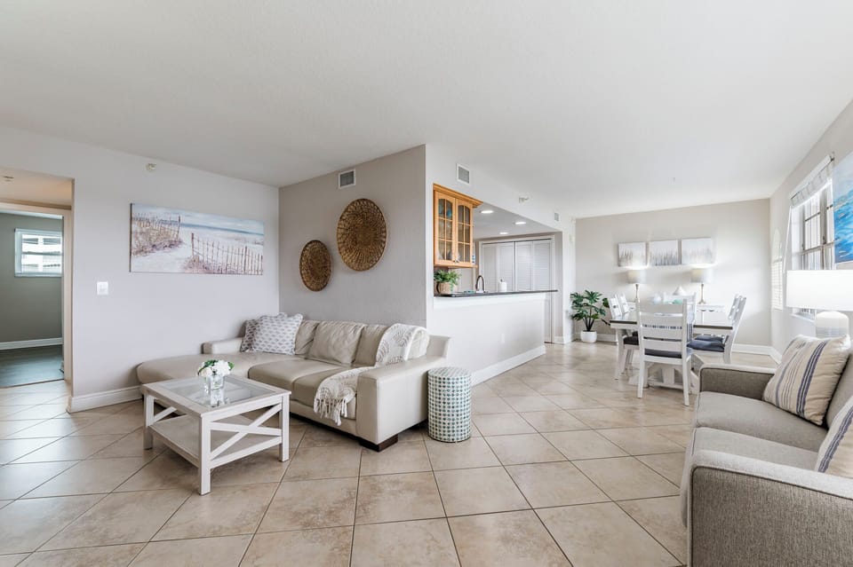 Thoughtfully designed open-concept living room with bay views, featuring a large smart TV and plenty of space to stretch out and unwind.