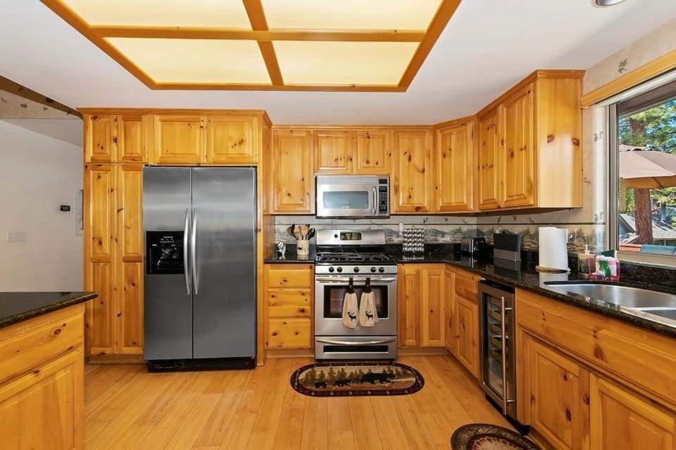 Cook in style with our modern kitchen featuring wooden cabinetry and stainless steel appliances