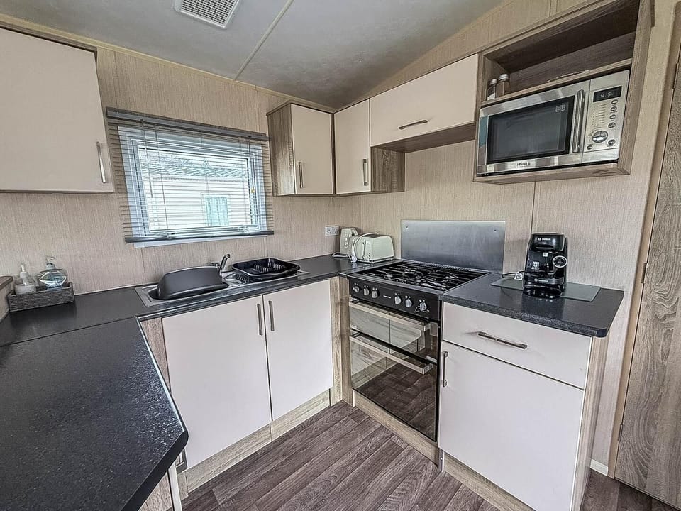 Discover the perfect family holiday UK experience at Kessingland Beach Holiday Park Suffolk, where Parkdean Resorts Kessingland Beach offers cosy caravan holidays UK with a comfortable kitchen area of a caravan for your convenience.