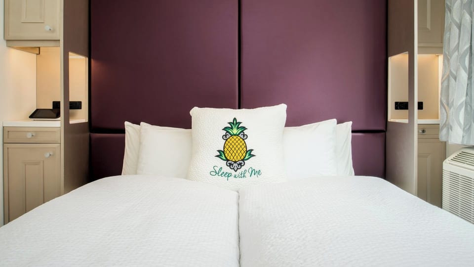 Stretch out in a perfectly made bed with luxe headboard.