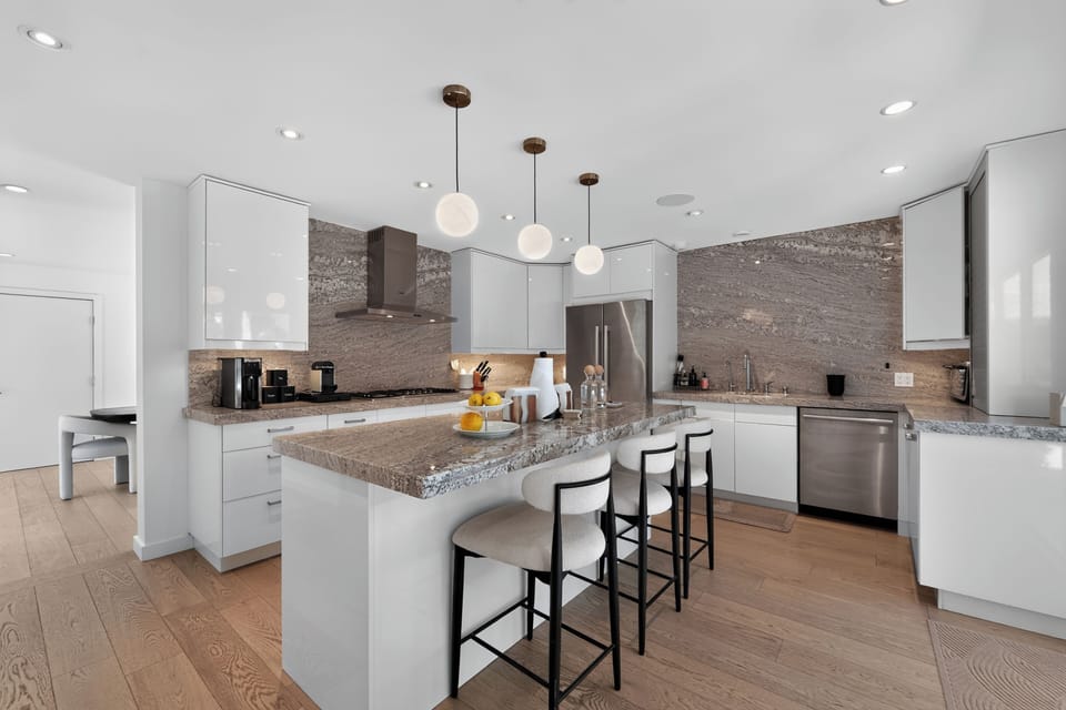 Additional barstool seating at the kitchen island.