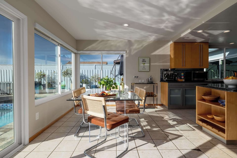 Dining area with seating and large windows