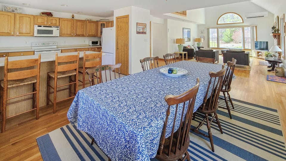 Dining area with kitchen with counter seating beyond