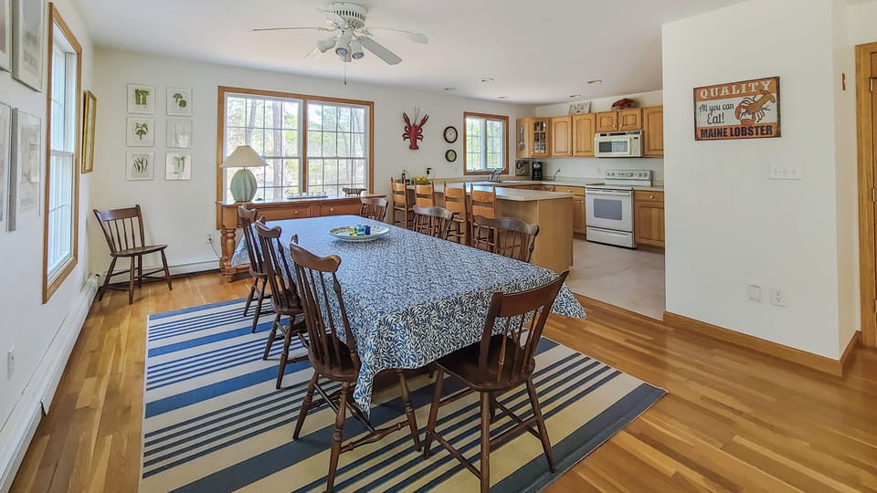 Dining area with large table adjacent to kitchen