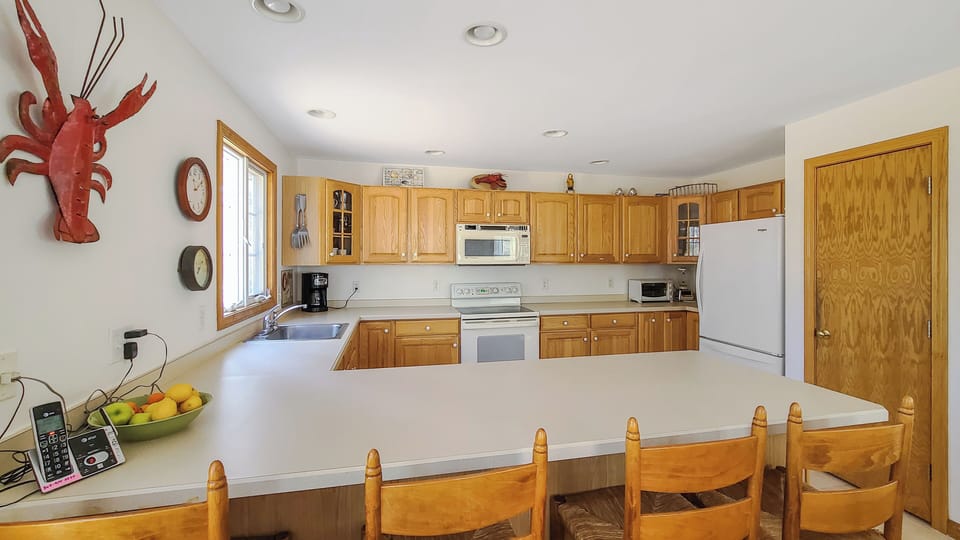 Nicely equipped kitchen has counter seating