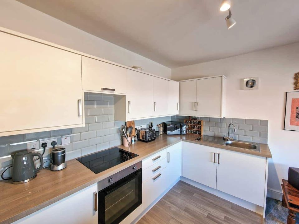 Kitchen with everything you need including microwave, kettle, toaster and complimentary tea and coffee. Washing machine perfect for longer stays