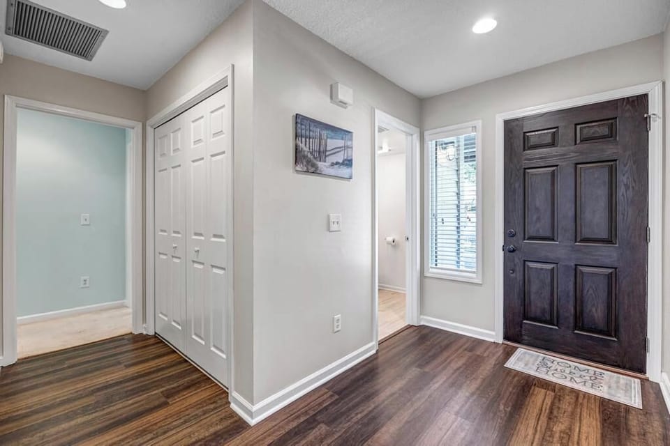 - Welcoming entryway features wood look floors, a bold front door, and natural light
- Hallway access to bedrooms, laundry, and closets for easy guest convenience
- Clean, modern layout sets the tone for a comfortable and stylish stay