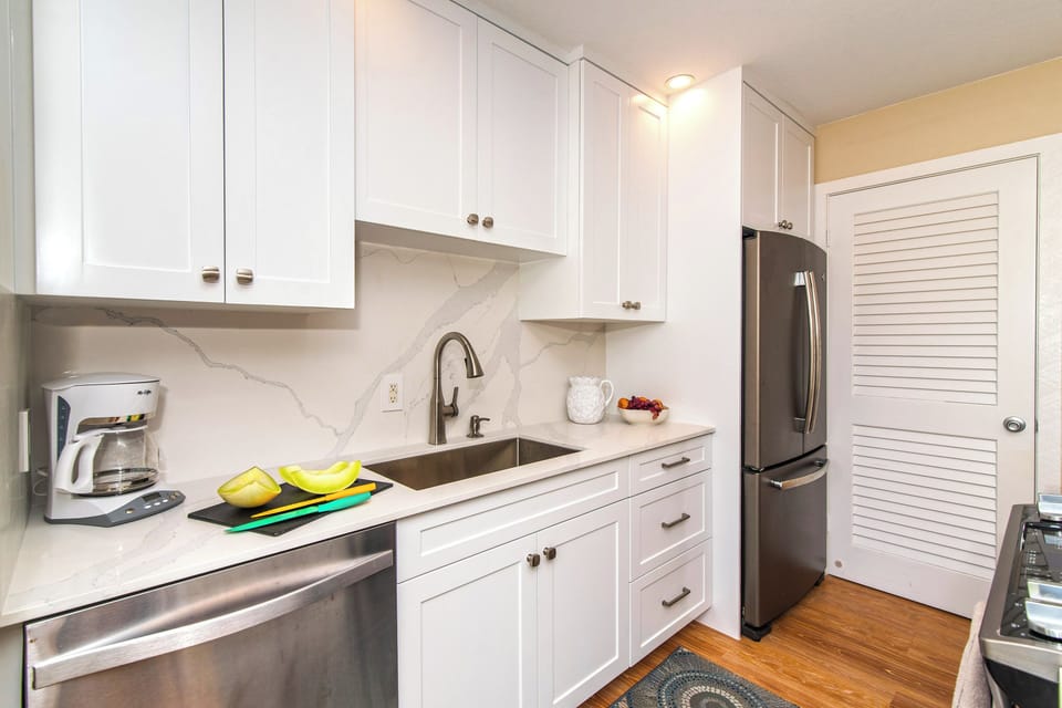 Full kitchen with modern appliances and a drip coffee maker. 