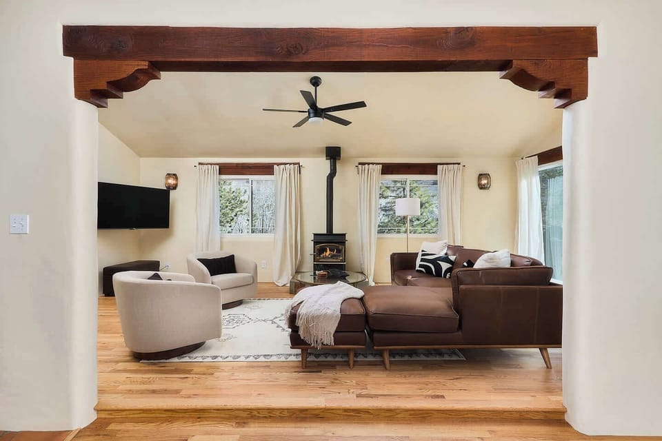 Upstairs living room. Gas fireplace. Timber framing and wood floors. 