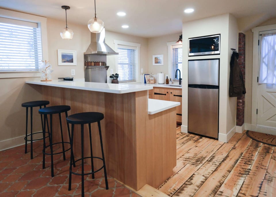 Fully stocked kitchen with bar seating for 3.