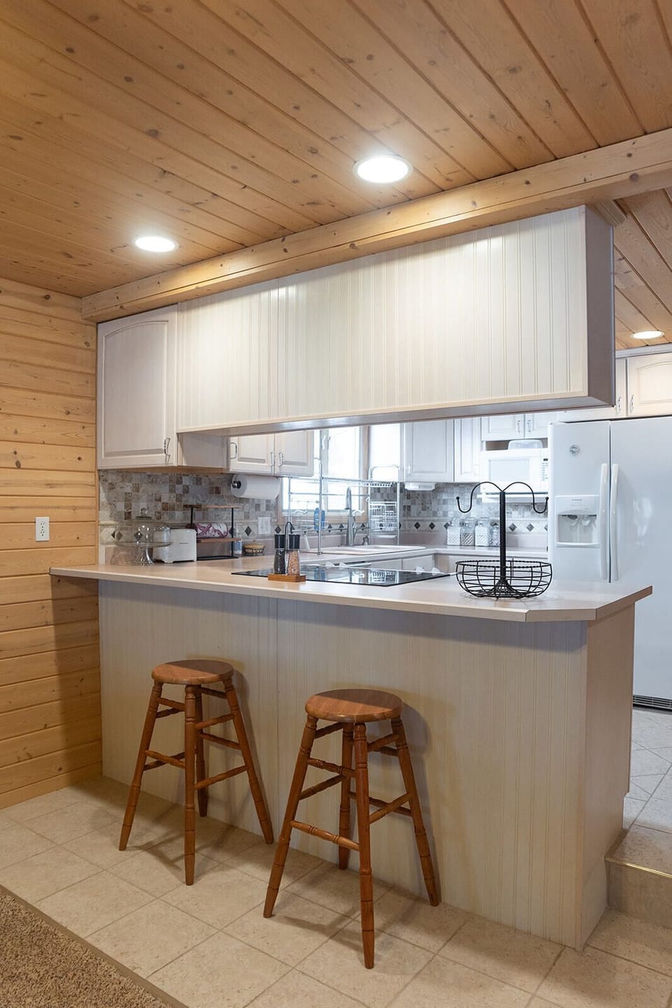 Bar seating at the kitchen peninsula.
