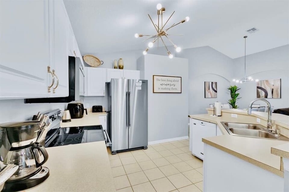 Fully stocked kitchen with modern stainless steel appliances 