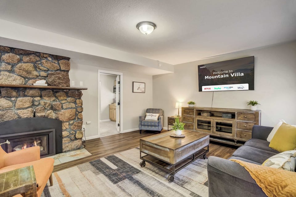 Cozy up in the inviting living room, featuring a rustic stone fireplace, stylish decor, and a Smart TV for entertainment. The perfect blend of comfort and charm for your mountain getaway!






