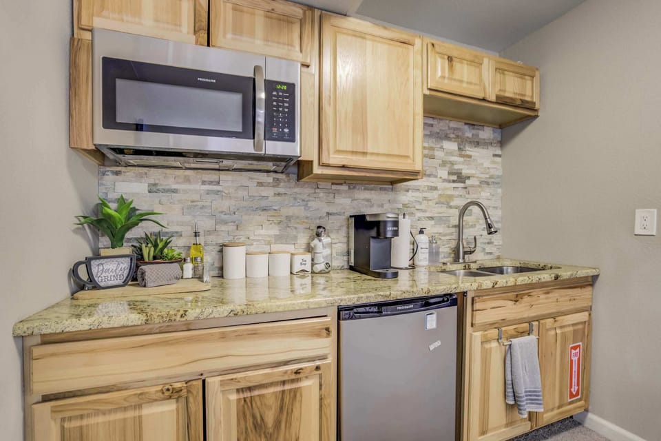 A well-equipped kitchenette for a hassle-free stay – featuring a microwave, dishwasher, coffee maker, and stylish backsplash, this space is perfect for preparing quick meals and snacks.





