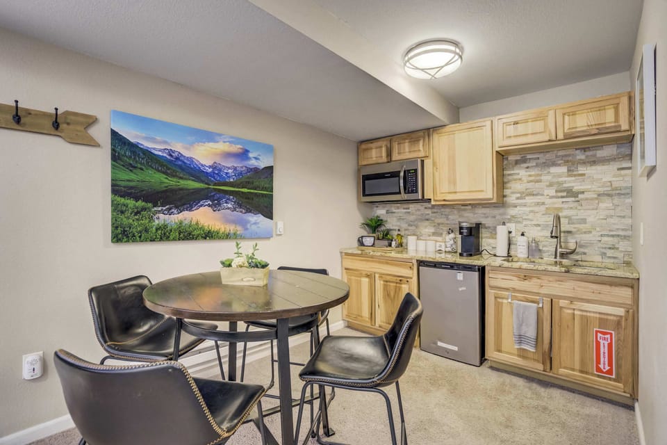 A well-equipped kitchenette for your convenience – featuring a microwave, mini fridge, coffee maker, and ample storage. Enjoy meals or a morning coffee at the stylish dining table with mountain-inspired decor.





