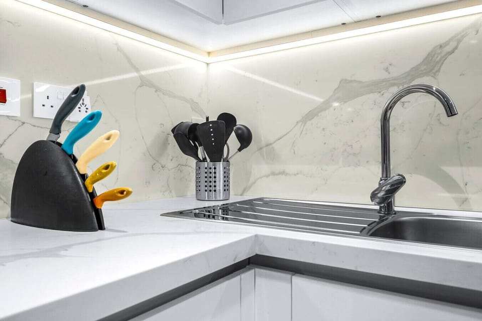 Kitchen: Sleek marble finishes and vibrant utensils – unleash your inner chef in style!