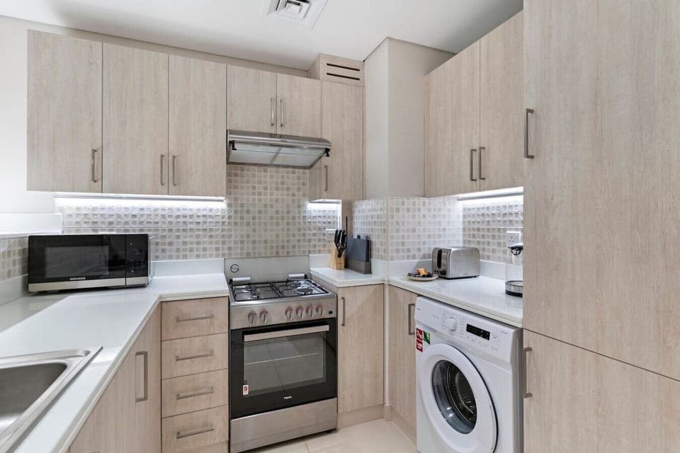 Kitchen: Culinary adventures await in this sleek, modern kitchen with top-notch appliances!