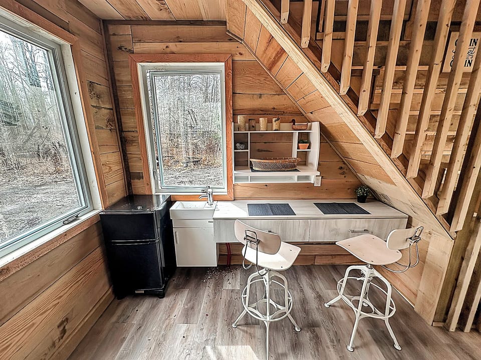 Kitchenette area with small fridge, freeze and sink with running water (well water, drink at your own risk)!