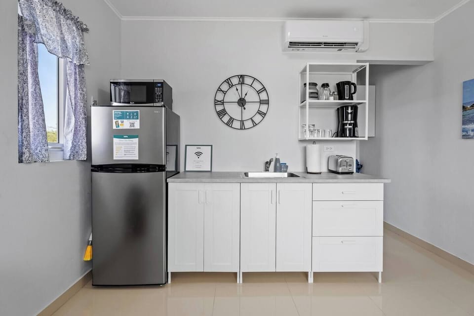 Fully equipped kitchen with modern appliances and storage.

