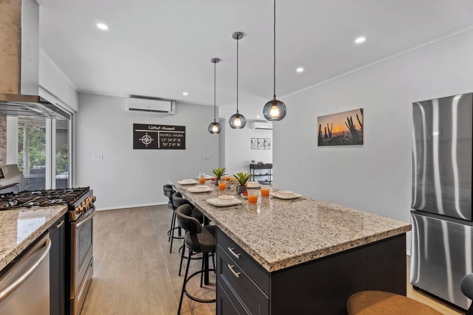 Fully equipped modern kitchen with a central island for cooking and dining.