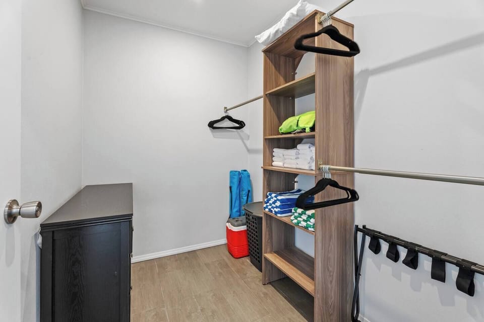 Walk-in closet with plenty of storage and hanging space.

