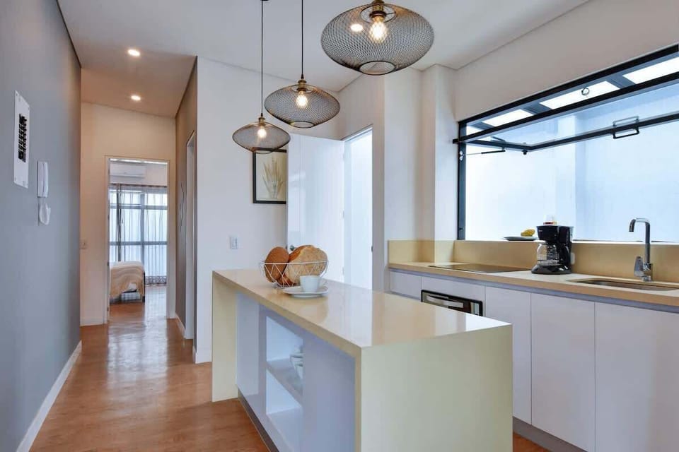 Open kitchen and hallways that connects to bedrooms in back.