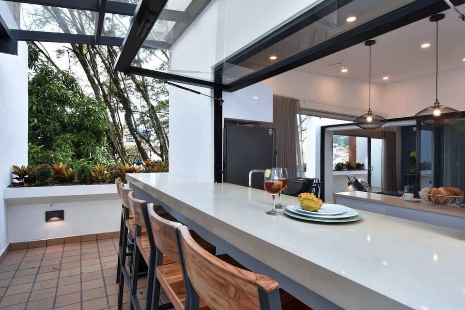 Kitchen that connects to an outdoors bar.