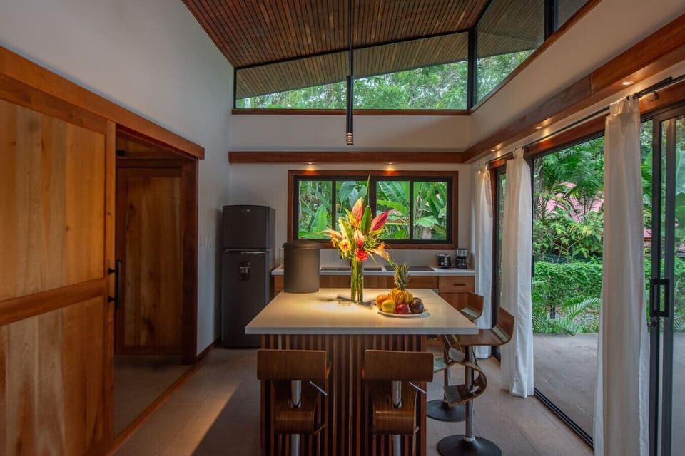 Modern kitchen with island seating, high ceilings in Playa Negra, Casa Kanani
