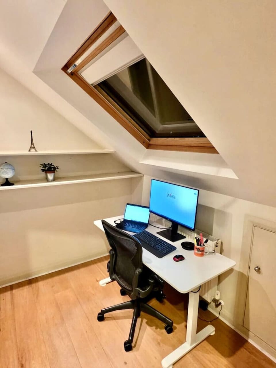 Dedicated workspace in attic under skylight