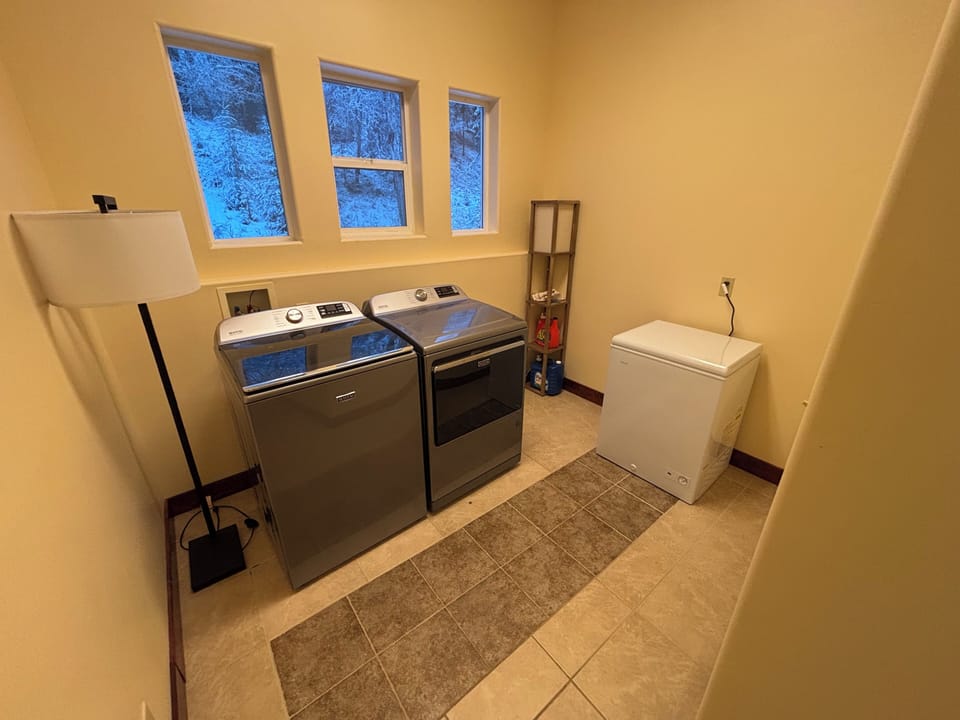 Full sized laundry room with chest freezer for fish storage