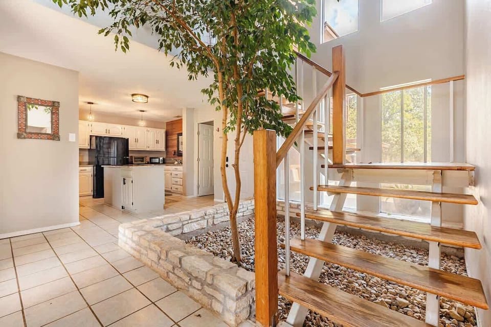 This beautiful real ficus tree sits proudly in the center atrium, bringing a touch of nature indoors. It adds warmth, life, and a peaceful vibe to the home, making the space feel like a serene indoor garden retreat. A unique part of this house.