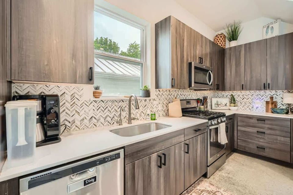 Sleek and modern design meets functionality in this fully stocked kitchen.