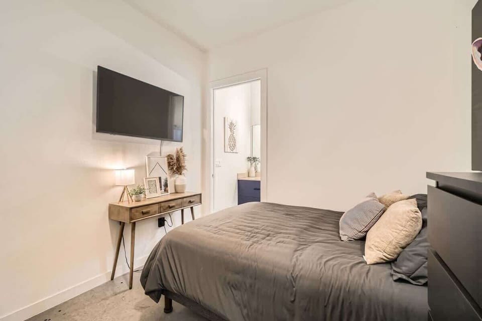 This bedroom features a plush queen bed, soft linens, and calming decor to ensure a restful night’s sleep.