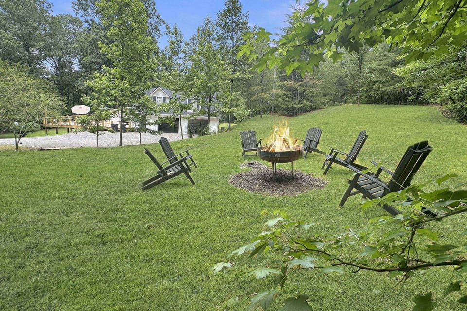Or head out to the ultimate outdoor property - 10 acres to explore with fire pit, hot tub, oversized deck and open area game room!