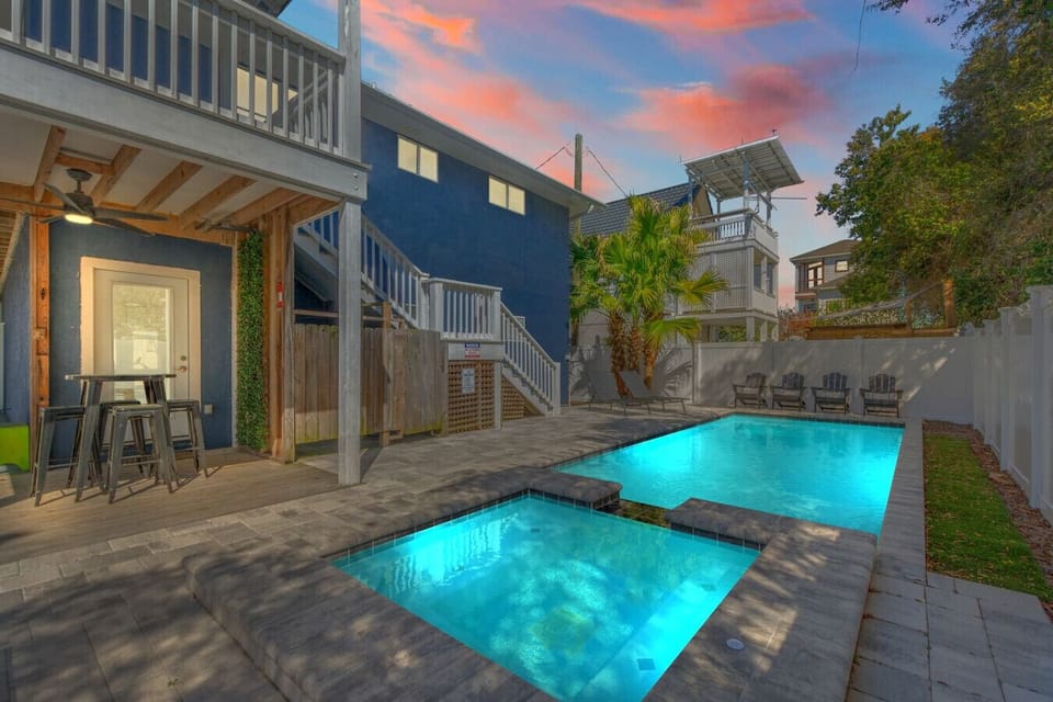 A view of the backyard with a pool creates a relaxing and inviting atmosphere. The sparkling water serves as the perfect backdrop for outdoor gatherings, offering a refreshing space to unwind, swim, or lounge in the sun. Whether it`s surrounded by greener