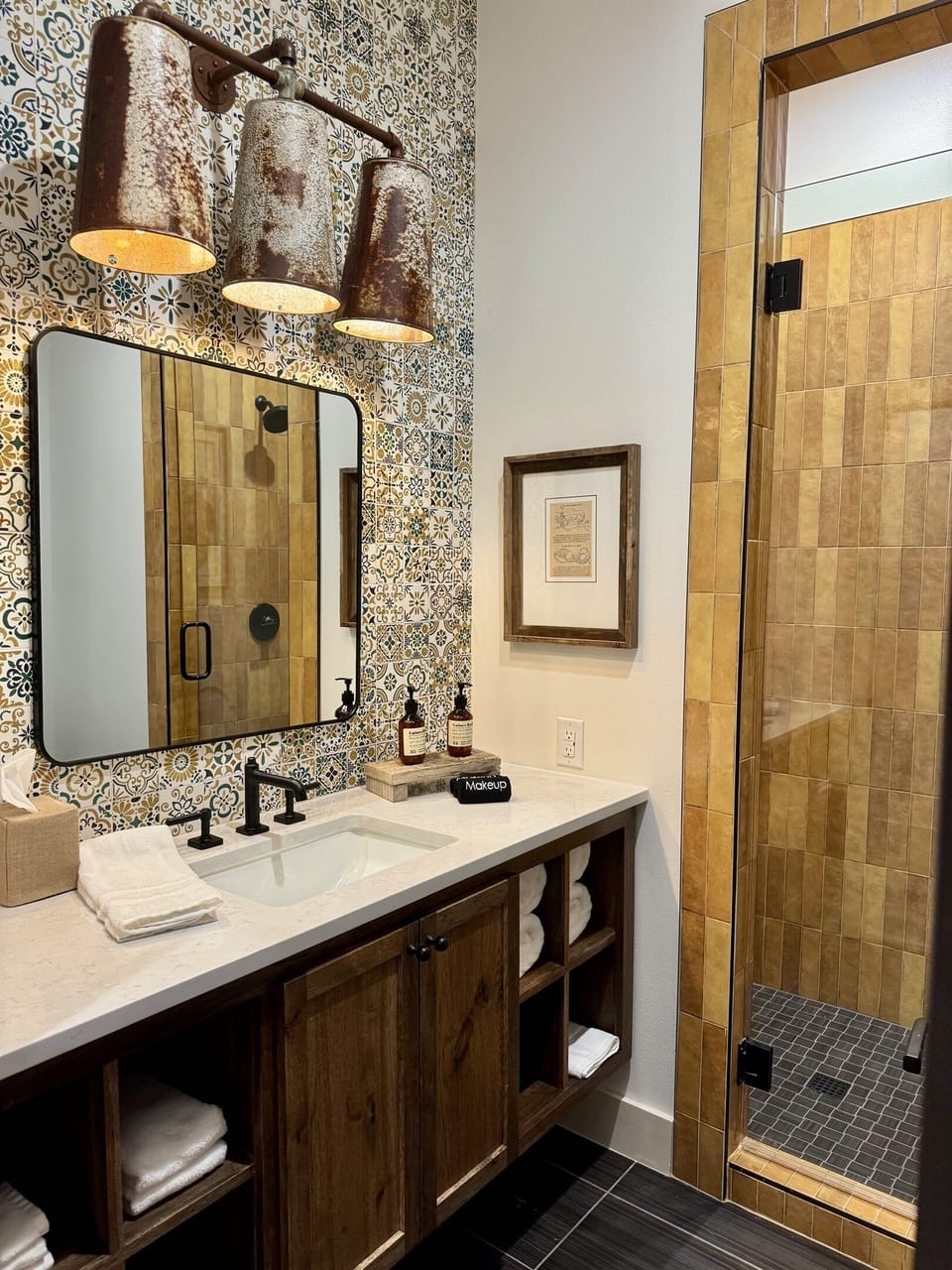 Lazy Spur Suite bathroom — designer vanity, copper pendant lighting, and modern Western tile. Another private en-suite at the Gaines Ranch on the Square entire property.