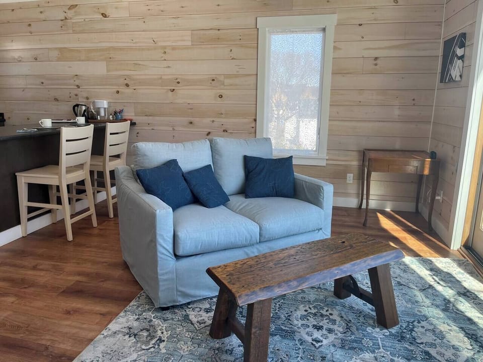 Light-filled space! Comfy sofa, wood details, & warm feel. Perfect for unwinding.