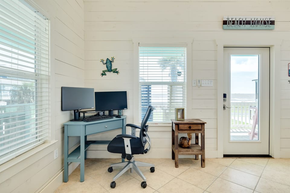 For anyone needing to connect during their beach getaway, there's a fully equipped workstation with a docking station, dual monitors, keyboard, and mouse