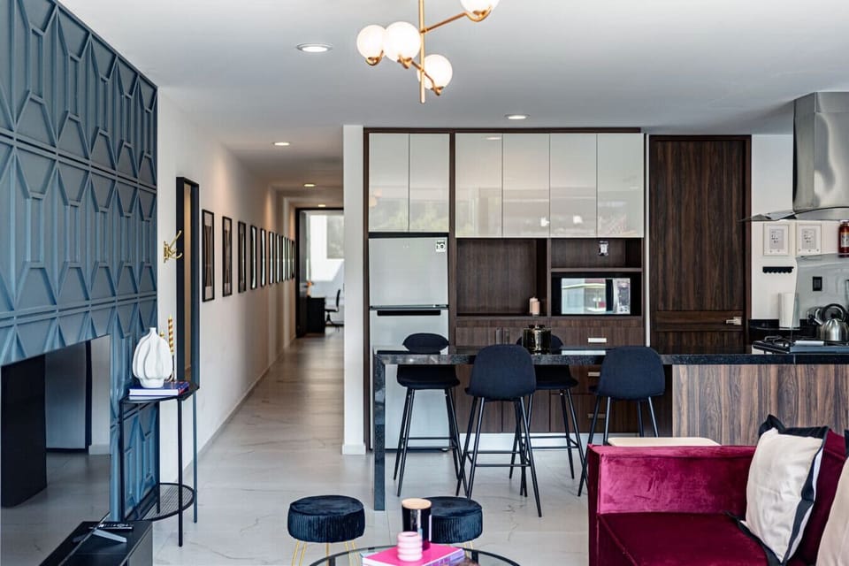 Open-concept design connecting kitchen, dining, and living areas with chic decor