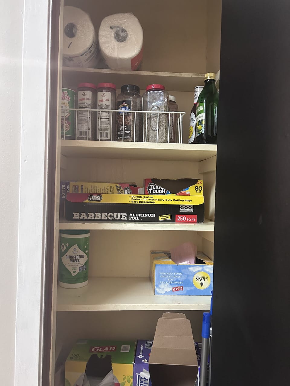 Pantry with extra spices, foil, ziplock bags.