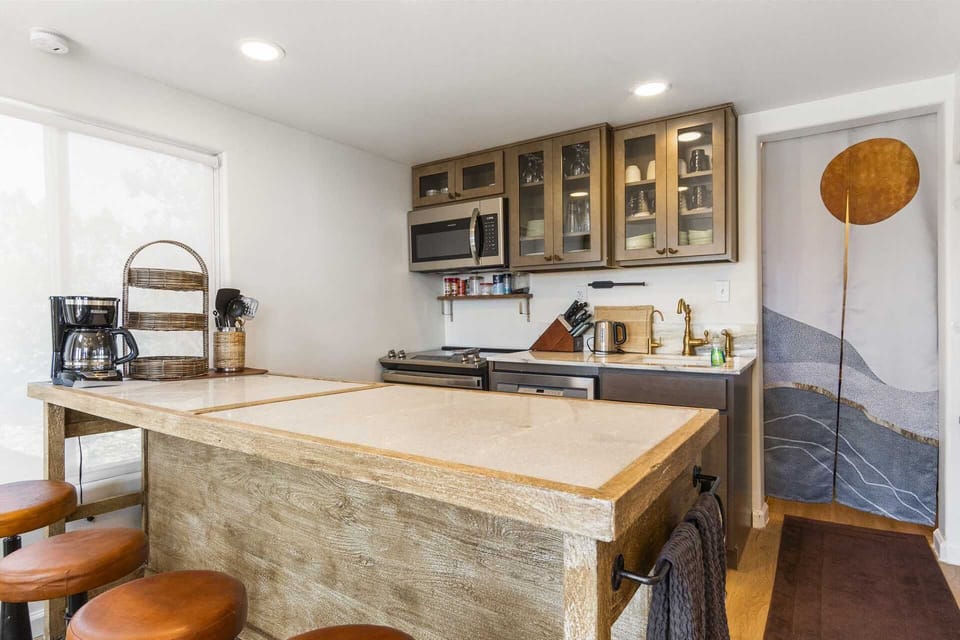 Charming and fully stocked kitchen with cozy bar seating-perfect for morning coffee or evening wine.