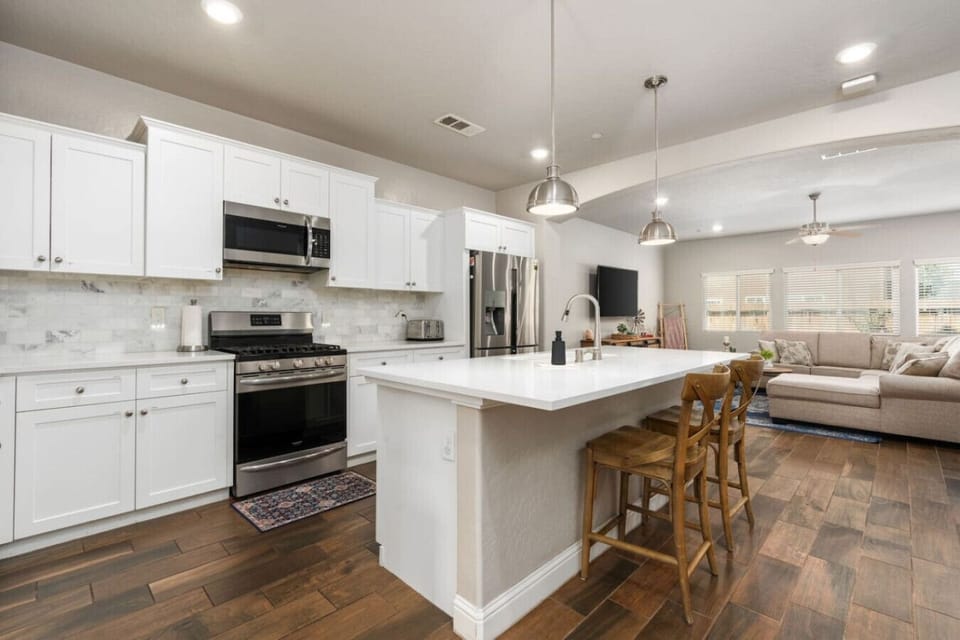 Modern Kitchen Island with Stools! Gather around the sleek granite island, complete with stylish stools, for casual meals, morning coffee, or great conversations. A perfect spot for relaxing and enjoying the heart of the kitchen.